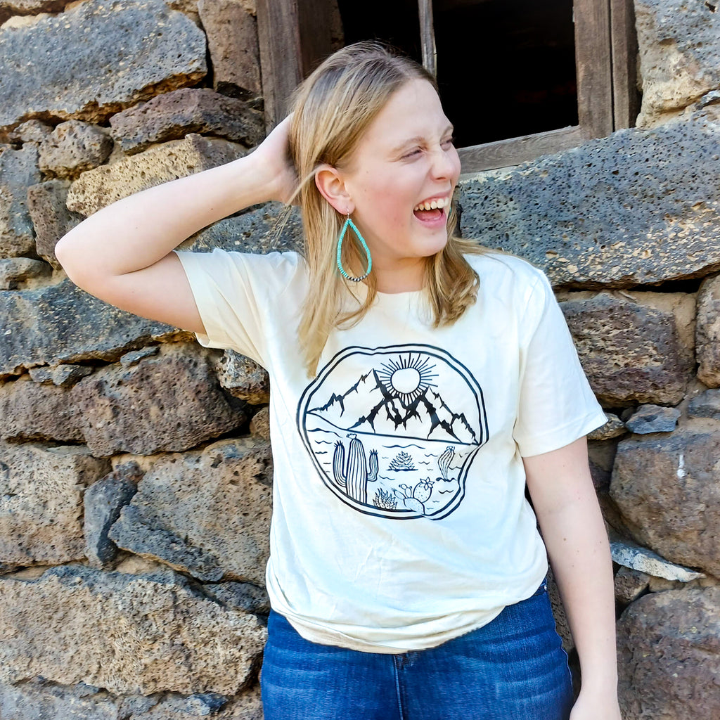 A girl laughing wearing a Western desert  cactus tee